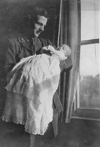Tim as a baby, held by his father, Basil Cranmer Dening